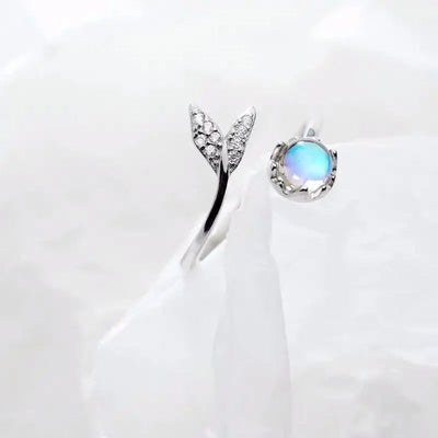 Adjustable ring with dolphin tail made of sterling silver and blue zirconium dioxide